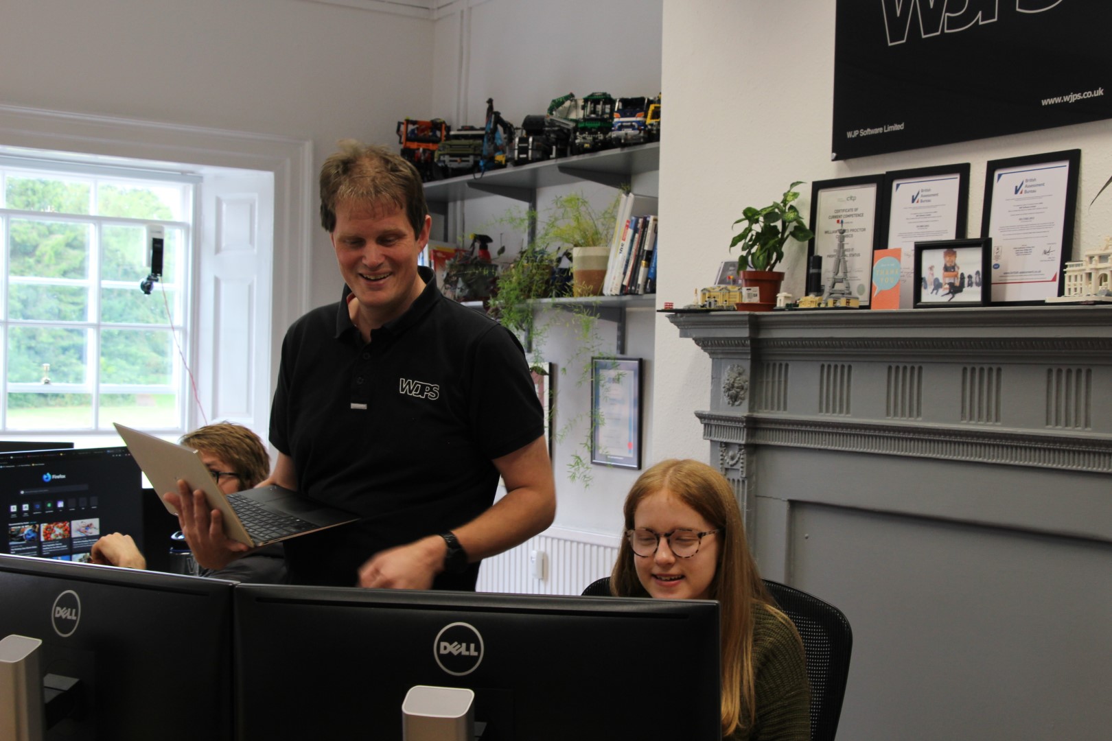 Eve and James working together in the WJPS Office